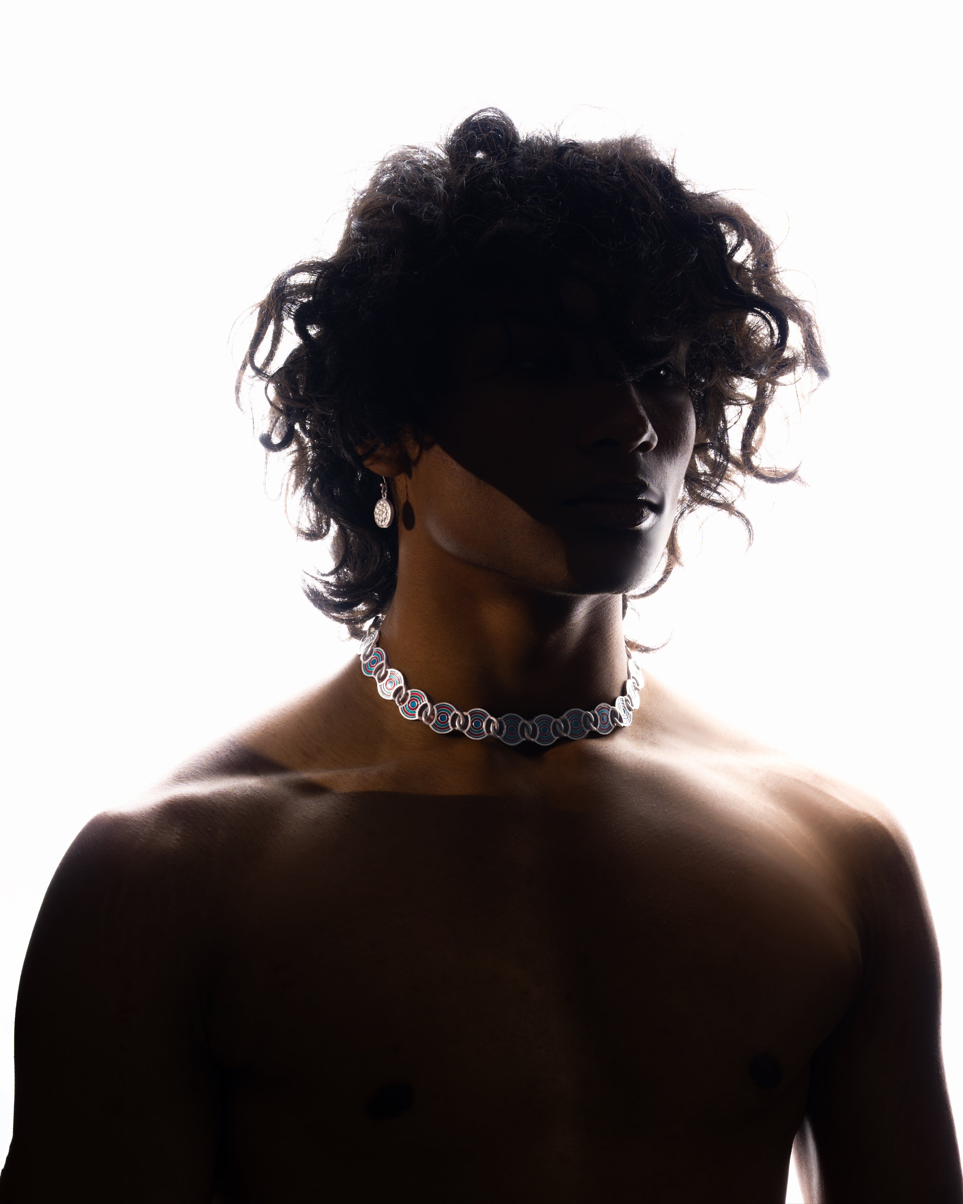 Silhouette of a person wearing a necklace on a white background